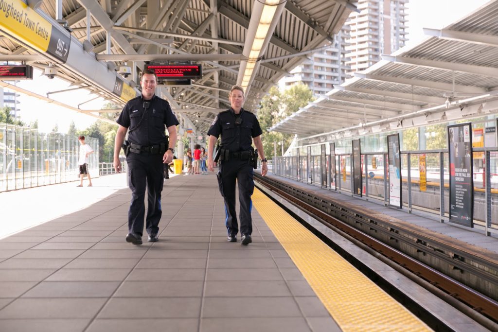 Two Officers Walking on the SkyTrain Platform