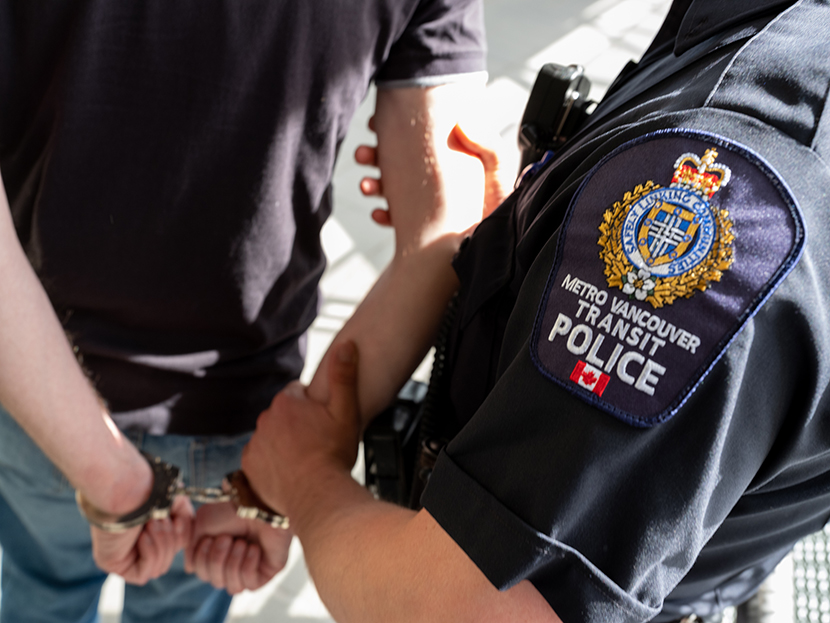 A man is being arrested by a Transit Police officer